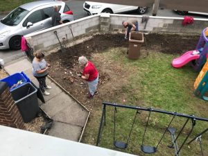 Jane Jackson, Matthew Dashper-Hughes and Jemma Hancock keep on going to remove the roots from the garden.