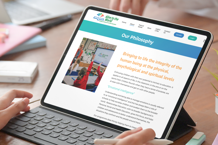 iPad with keyboard showing Alive to the World, Philosophy page