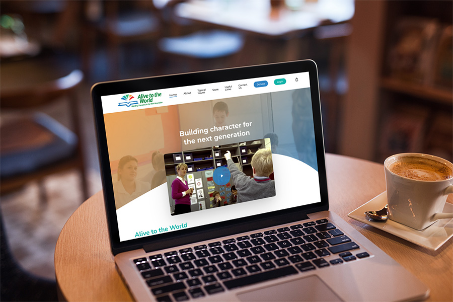 Alive to the World homepage design displayed on a computer screen